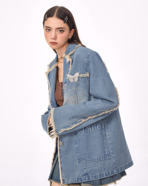VILZSTUDIOS Ripped denim blazer with butterfly pin and frayed edges