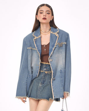 VILZSTUDIOS Ripped denim blazer with butterfly pin and frayed edges