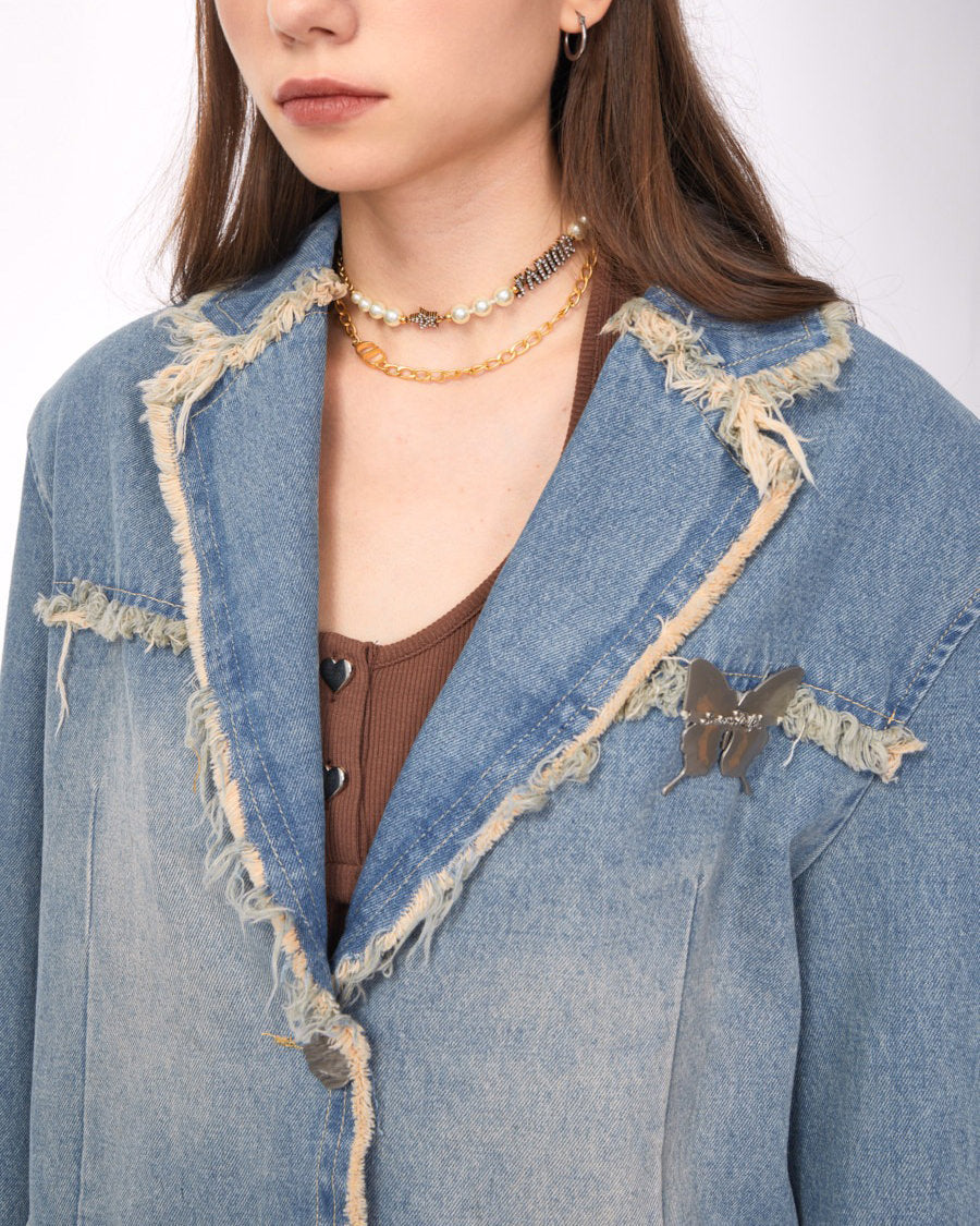VILZSTUDIOS Ripped denim blazer with butterfly pin and frayed edges