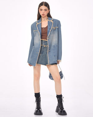 VILZSTUDIOS Ripped denim blazer with butterfly pin and frayed edges