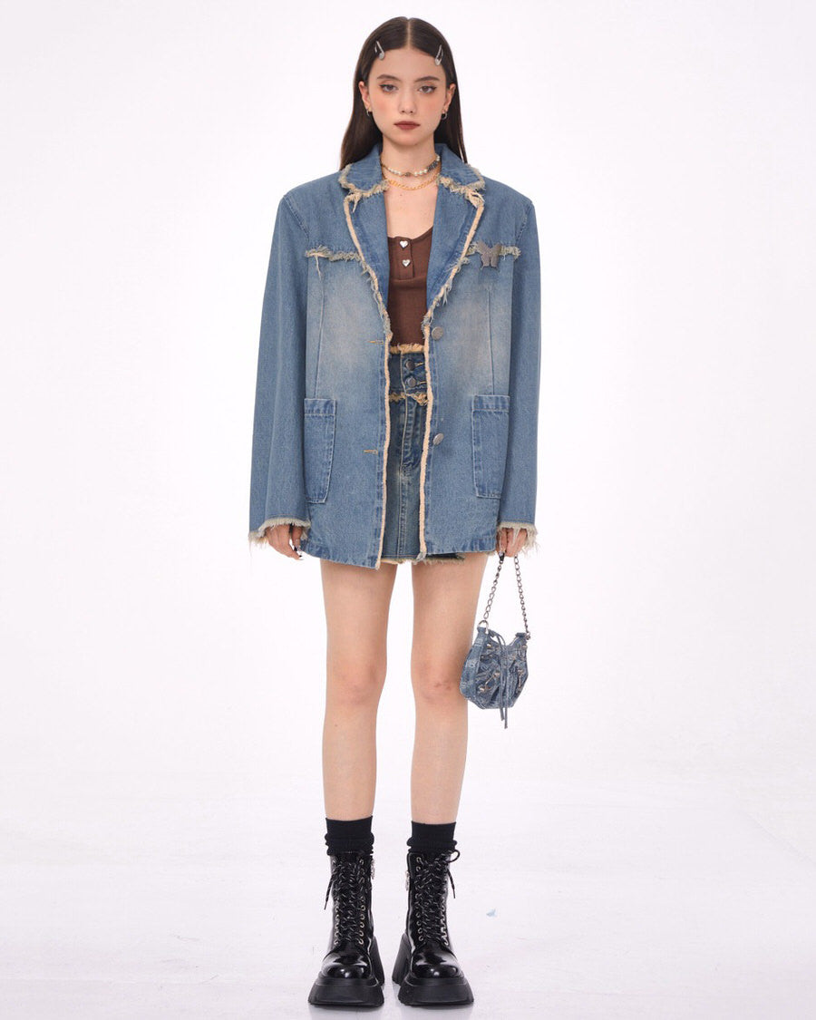 VILZSTUDIOS Ripped denim blazer with butterfly pin and frayed edges