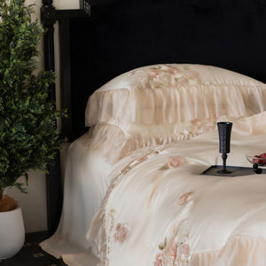 VILZSTUDIOS pale blush pink satin bedding set with rose embroidery and sheer ruffled edges