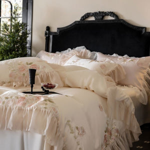 VILZSTUDIOS pale blush pink satin bedding set with rose embroidery and sheer ruffled edges