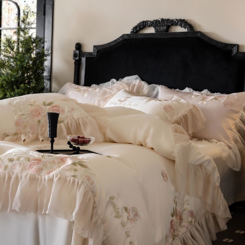 VILZSTUDIOS pale blush pink satin bedding set with rose embroidery and sheer ruffled edges