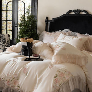 VILZSTUDIOS pale blush pink satin bedding set with rose embroidery and sheer ruffled edges