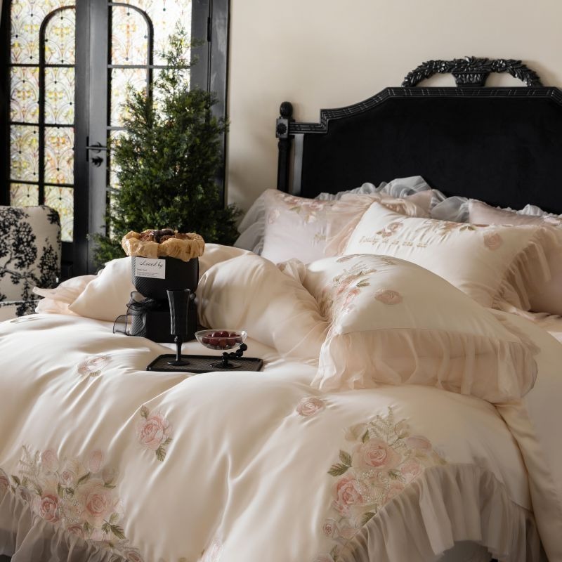 VILZSTUDIOS pale blush pink satin bedding set with rose embroidery and sheer ruffled edges