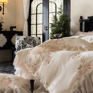 VILZSTUDIOS pale blush pink satin bedding set with rose embroidery and sheer ruffled edges