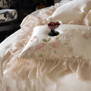 VILZSTUDIOS pale blush pink satin bedding set with rose embroidery and sheer ruffled edges