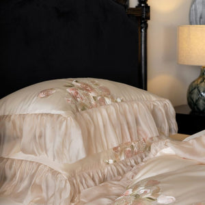 VILZSTUDIOS pale blush pink satin bedding set with rose embroidery and sheer ruffled edges