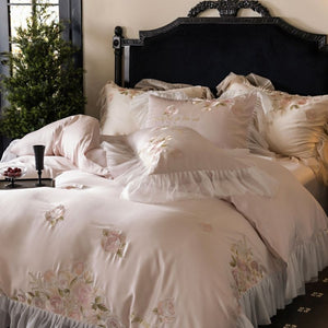 VILZSTUDIOS pale blush pink satin bedding set with rose embroidery and sheer ruffled edges