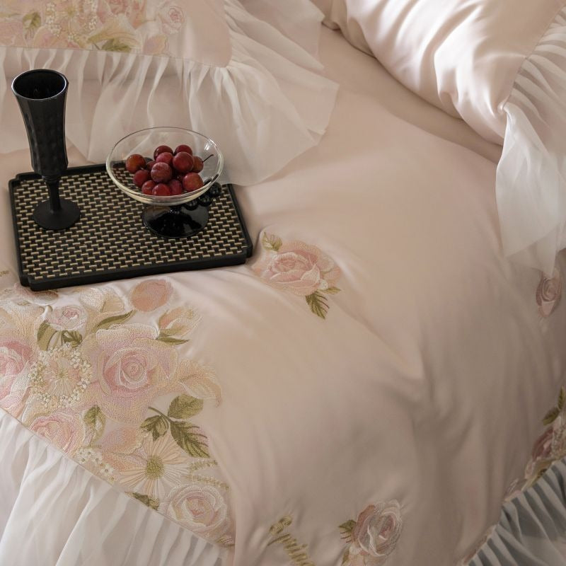 VILZSTUDIOS pale blush pink satin bedding set with rose embroidery and sheer ruffled edges