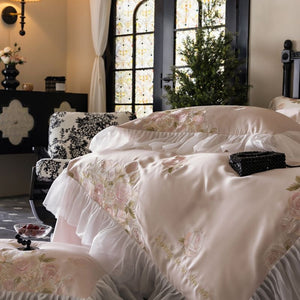 VILZSTUDIOS pale blush pink satin bedding set with rose embroidery and sheer ruffled edges