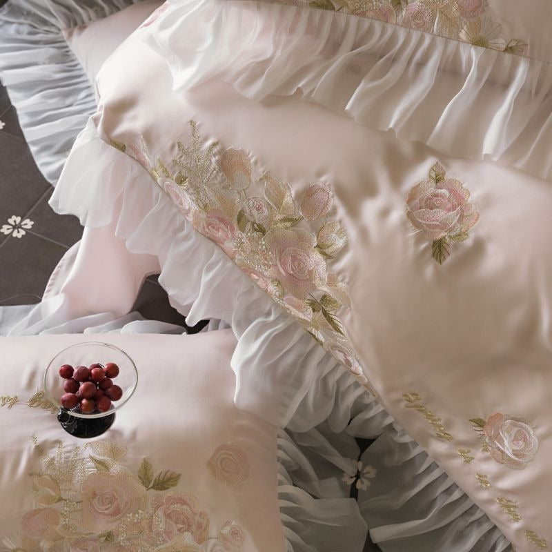 VILZSTUDIOS pale blush pink satin bedding set with rose embroidery and sheer ruffled edges