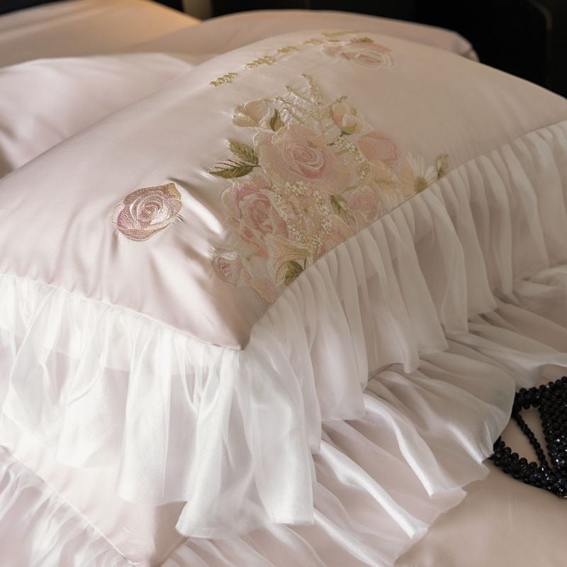 VILZSTUDIOS pale blush pink satin bedding set with rose embroidery and sheer ruffled edges