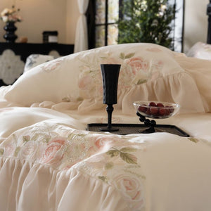 VILZSTUDIOS pale blush pink satin bedding set with rose embroidery and sheer ruffled edges