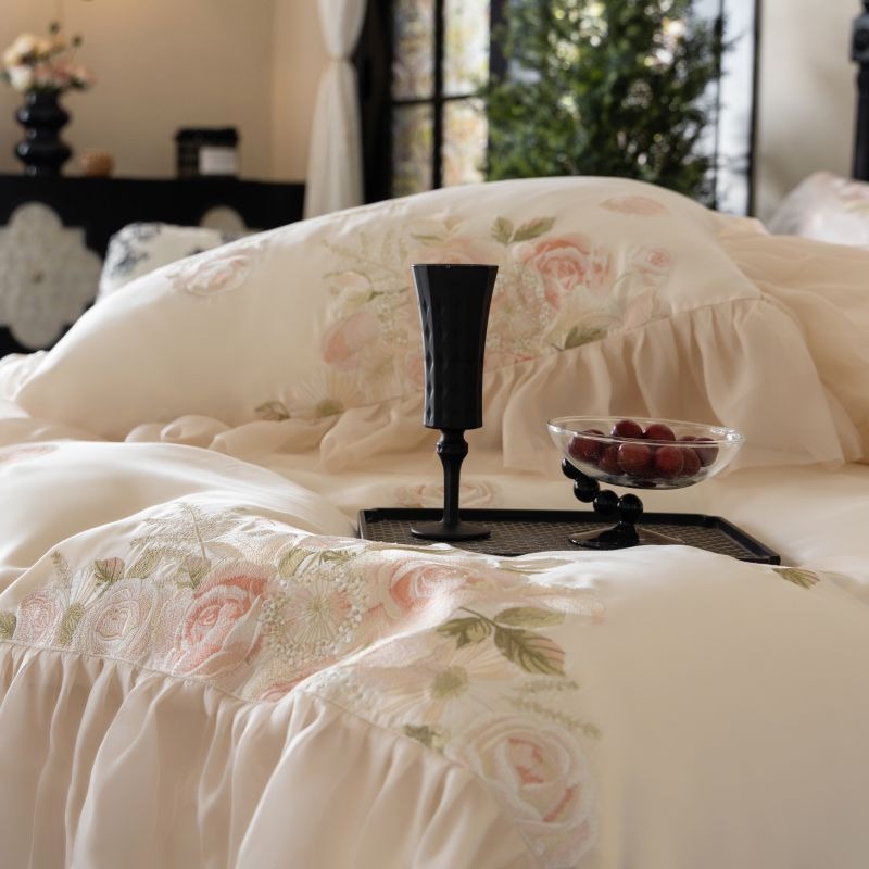 VILZSTUDIOS pale blush pink satin bedding set with rose embroidery and sheer ruffled edges