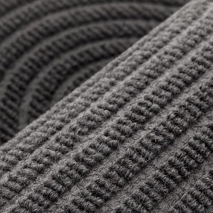VILZSTUDIOS neutral rectangular door mat with sculpted wave patterns and embossed ribbed ridges
